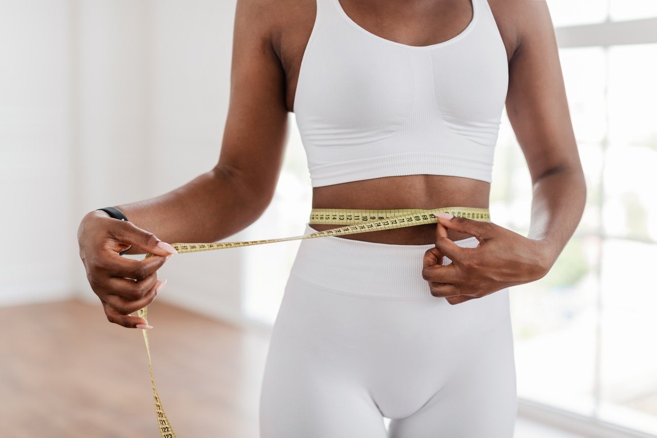 Woman Measuring Waist with a Measuring Tape 